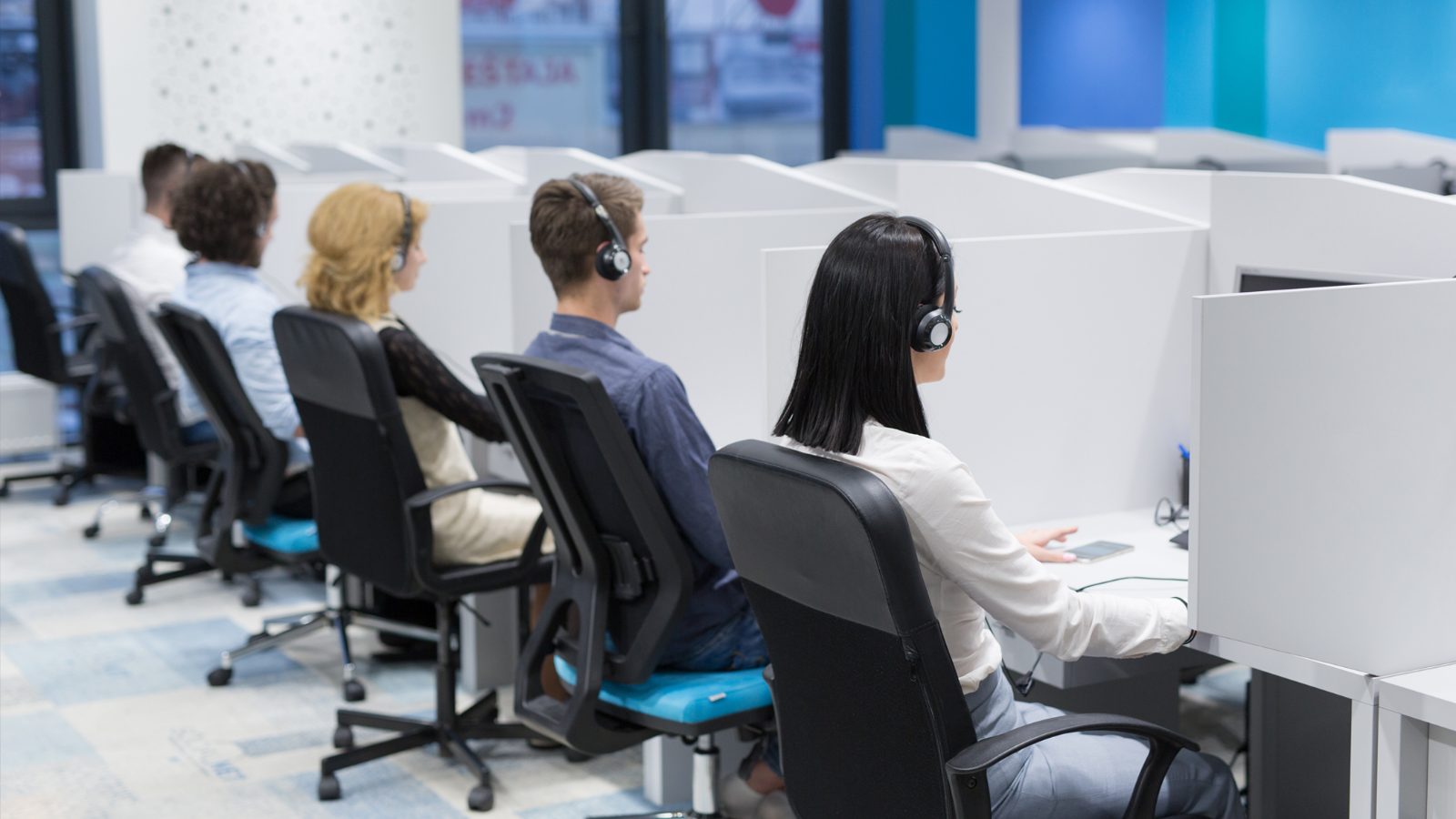 Rows of customer service agents on headsets in the Sphere Sync Connect support centre